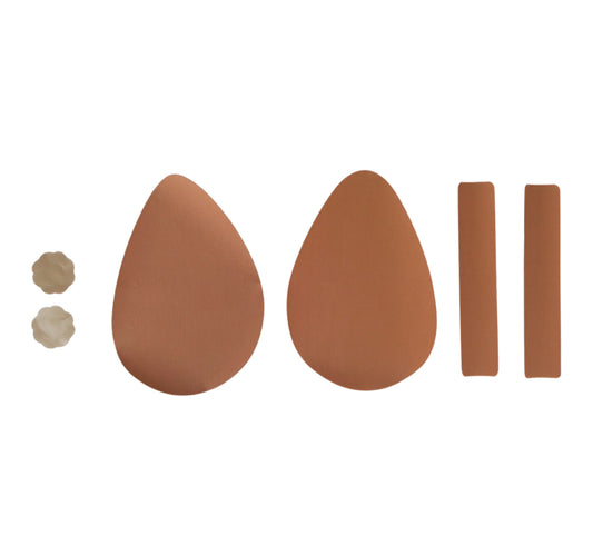 Arrangement of 2 Nude, flower-shaped NIPPLE COVERS, a pair of sand-coloured EGG CUPS, and a pair of Sand TITTY TAPE